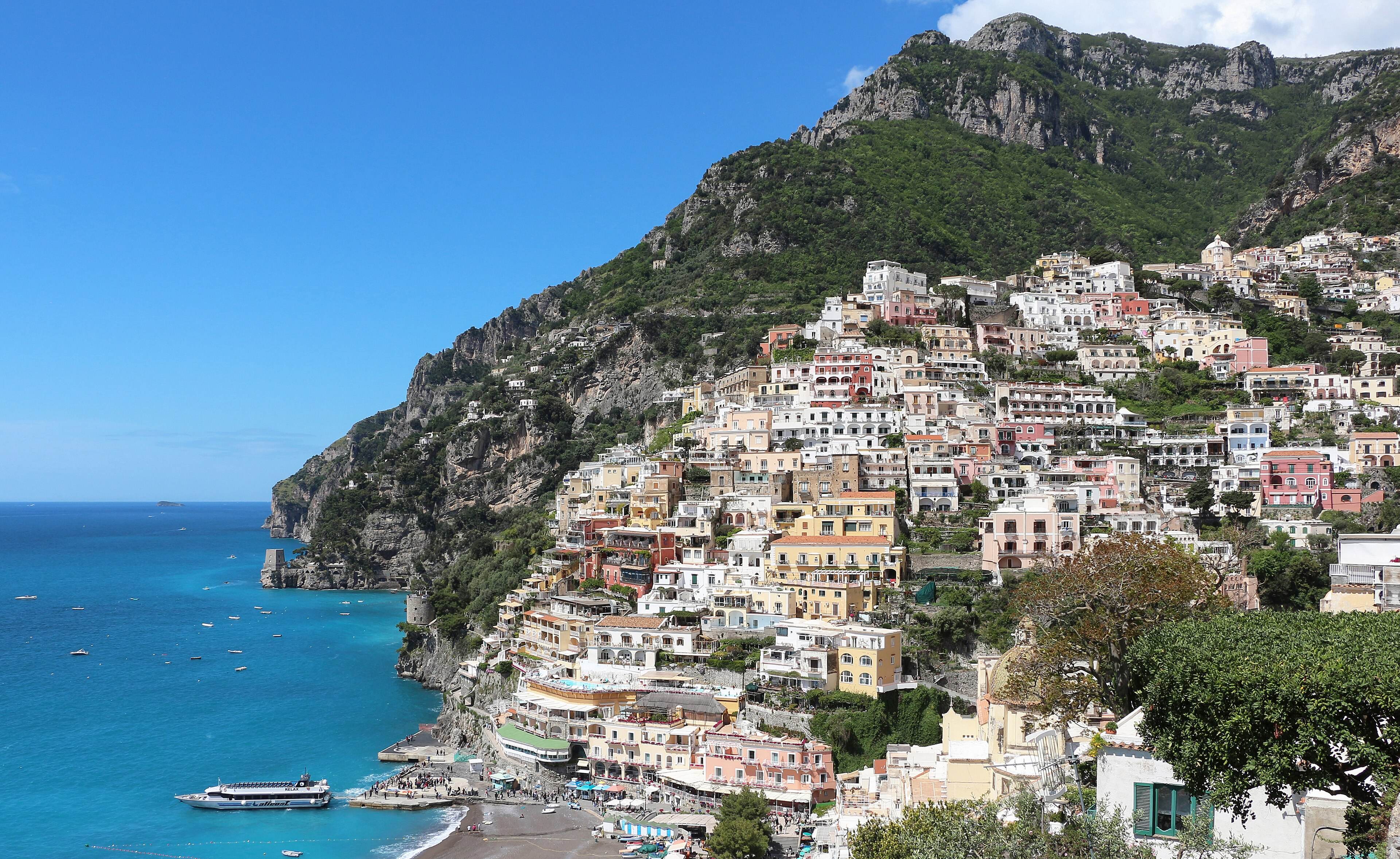 Positano’s pastel houses stacked up the hillside above the beach